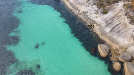 Drone-aerial-showing-blue-water-over-a-coastal-area-in-Australia