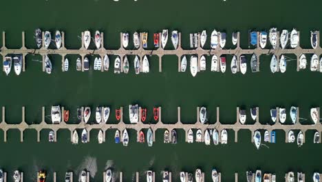 Overhead-shot,-beginning-wide-and-pushing-in-to-reveal-boats-on-a-marina-on-a-sunny-day