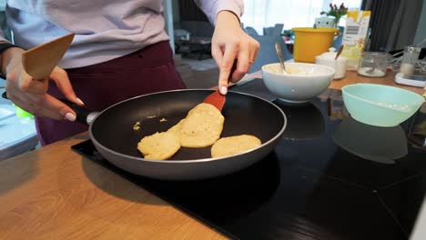 Foto-De-Una-Mujer-Cocinando-Panqueques-En-La-Cocina-De-Su-Casa-Por-La-Mañana-Para-Desayunar