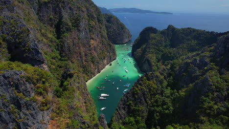 Aerial-view-of-touristic-boats-entering-in-PiLeh-lagoon,-Thailand