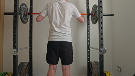 static-shot-of-a-young-man-setting-the-bar-ready-for-barbell-squats