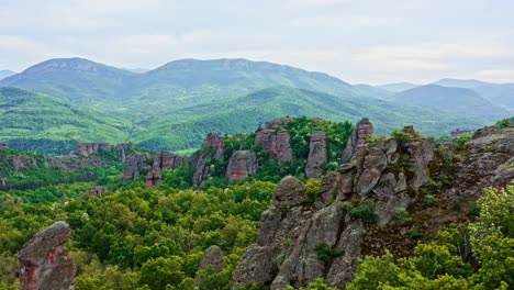 Belogradchik-rock-formations-in-beautiful-Bulgarian-forests-landscape,-Drone-shot