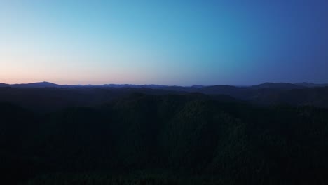 Night-time-drone-shot-of-the-mountain-and-forest-silhouette