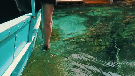 Filming-underwater-with-a-smart-phone-while-riding-on-a-boat-with-oars-in-pristine-water
