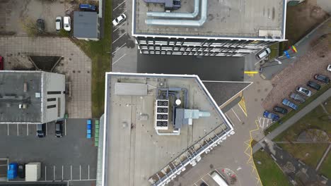 Aerial-shot-of-office-building-roof-with-heating,-ventilation-and-air-conditioning-equipment