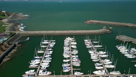 Overhead-shot,-beginning-on-the-right-and-moving-left-to-reveal-boats-on-a-marina-on-a-sunny-day