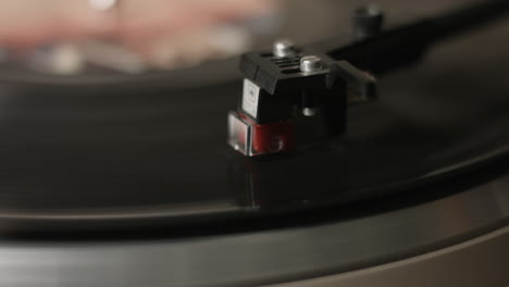 An-extreme-close-up-of-a-stylus-playing,-on-a-vintage-turntable,-a-record-player