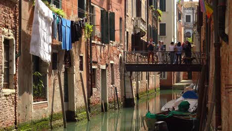 Menschen-Gehen-Auf-Einer-Steinbrücke-über-Den-Wasserkanal-In-Venedig