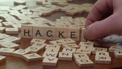 Narrow-focus-table-top:-Word-HACKED-formed-from-Scrabble-tile-letters