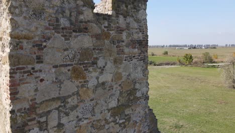 Aerial-descent-down-ancient-stone-wall-of-Soltszentimre-Truncated-Tower,-Hungary