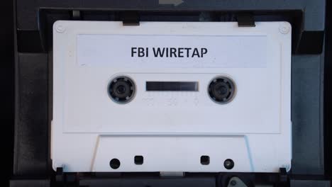 FBI-Wiretap-Recording-on-Audio-Cassette,-Interesting-and-Playing-Tape,-Close-Up