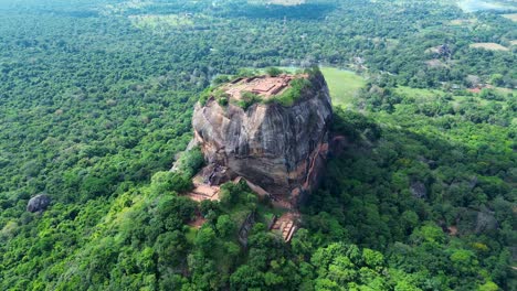 Aerial-drone-landscape-of-Sigiriya-ancient-rock-palace-fortress-in-Dambulla-forest-people-climbing-staircase-Sri-Lanka-travel-holidays-tourism-Asia