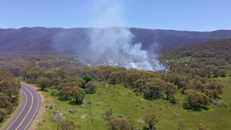 Forward-aerial-view-of-smoke-spreading-over-Crackenback-area-during-daytime-in-New-South-Wales,-Australia