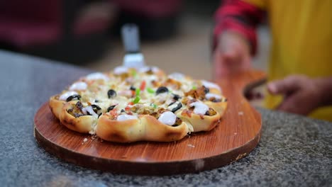 Pizza-chef-serving-freshly-baked-pizza