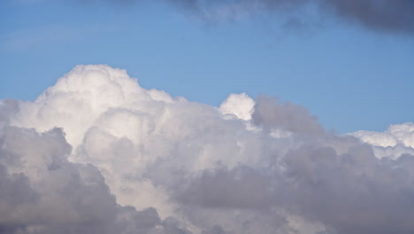 Timelapse-of-clouds-blooming-and-changing-shape-in-blue-sky,-telephoto-view