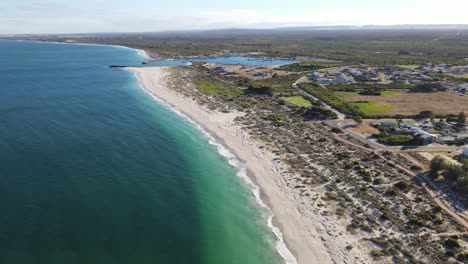Drone-aerial-over-a-pristine-beach-in-Australia-showing-a-harbour