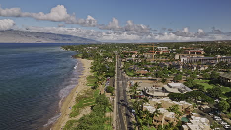 Kihei-Maui-Hawaii-Aerial-v9-low-drone-flyover-along-the-coastline-of-Kamaole-Beach-Park-capturing-town-center-of-the-island-and-mountain-landscape-views---Shot-with-Mavic-3-Cine---December-2022