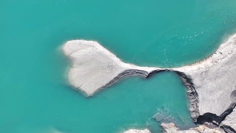 Drone-Footage-Heart-Shaped-Blue-Green-Water-Transparency-Lake-Shore