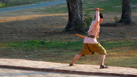 Boy-with-Thai-uniform-practicing-katana-movements