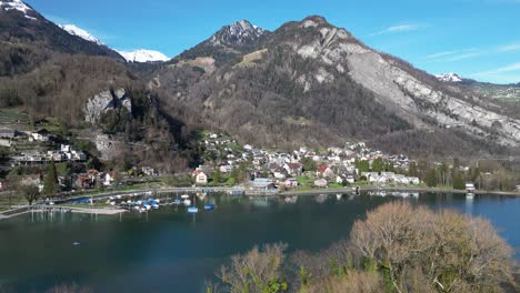 Drone-clip-of-village-and-lakeside-harbour-in-swiss-Alps-on-a-bright-sunny-day