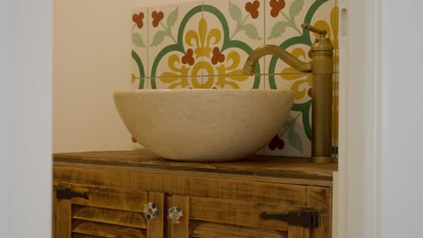 Slow-revealing-shot-of-an-antique-design-bathroom-with-washbasin-on-a-cabinet
