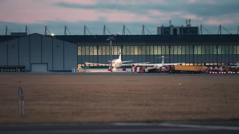 A-passenger-airplane-is-parked-near-the-hangars-in-the-Vaclav-Havel-airport,-Prague