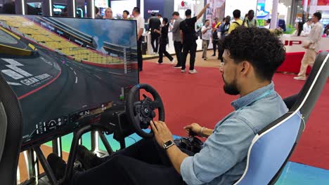 international-businessman-checking-out-gaming-rig-console-set-up-at-the-booth-Canton-import-and-export-Fair-in-Guangzhou,-China