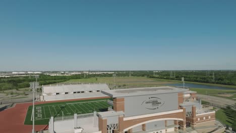 An-aerial-establishing-shot-of-the-CCISD-Challenger-Columbia-Stadium-beneath-blue-skies-in-League-City,-Texas