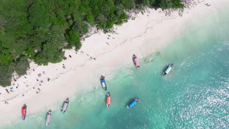 Nice-drone-shot-of-white-sandy-beach-and-turquoise-ocean-in-zanzibar-at-sunny-day