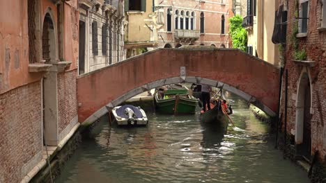 Gondola-Swims-Beneath-Stone-Arch-Bridge-in-Venice