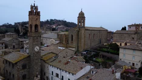 Aerial-view-of-the-clock-tower-in-the-old-town-Montalcino,-Italy,-establishing