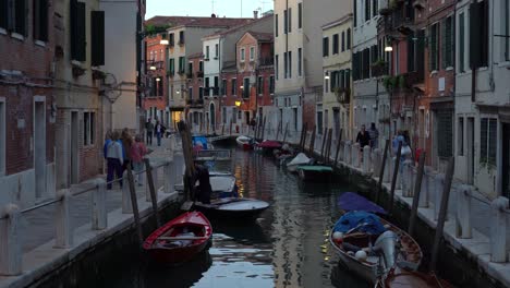 Boats-Parked-in-Water-Canal-in-Venice-on-a-Late-Spring-Evening