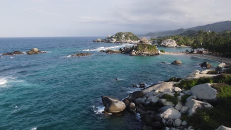 Aerial-view-low-over-the-rocky-coast-of-Cabo-San-Juan-in-Tayrona,-Colombia