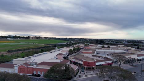 Drone-Flight-Carlsbad-Premium-Outlets-Covering-North-End-of-Mall-Flower-Fields-to-side-Background-Partial-Bloom-Colorful-stripes-and-Green