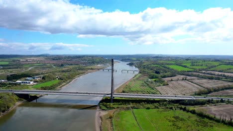 Drone-landscape-establishing-shot-traffic-crossing-the-Thomas-Francis-Meagher-Bridge-outside-Waterford-City-impressive-structure-and-bypassing-Waterford-City