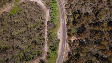 Aerial-top-down-shot-of-truck-passing-though-Alpine-road-way-in-Crackenback,-NSW,-Australia