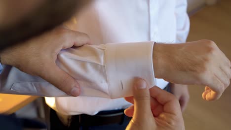 Assisting-groom-with-shirt-cufflinks-preparation
