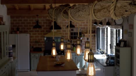 Slow-revealing-shot-of-rope-lights-hanging-from-a-log-in-a-villa-kitchen