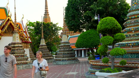 Caucasian-young-couple-visiting-Wat-Pho-temple-at-sunset