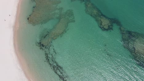 Drone-aerial-over-a-lagoon-showing-the-connection-to-the-ocean-in-Kalbarri