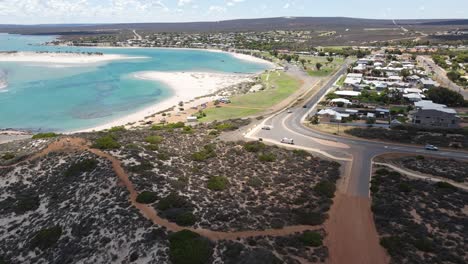 Drone-aerial-moving-towards-the-town-of-Kalbarri-and-a-blue-lagoon-on-a-sunny-day