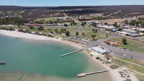 Drone-aerial-over-a-lagoon-with-a-boat-in-Kalbarri-town-centre-on-a-sunny-day