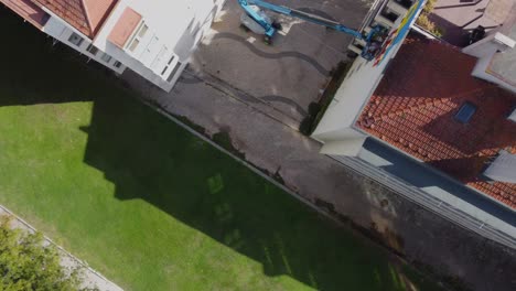 Topdown-Rotating-Drone-View-of-Residential-Buildings-and-Grass