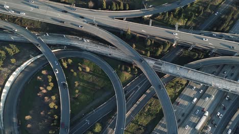 Arial-Flyover-of-Intersecting-Freeways-at-Sunset