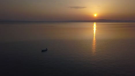 Sunset-in-Mediterranian-from-drone-capturing-greek-islands-and-aegean-sea-next-to-Halkidiki-with-boat