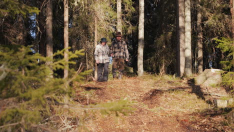 Senior-Couple-Holding-Hands,-Strolling-in-Pine-Forest-with-Together-with-Dog