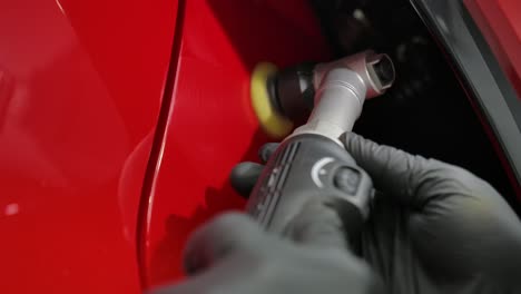 Mechanic-Worker-Hands-Polishing-A-Car-With-Polishing-Machine---Close-Up