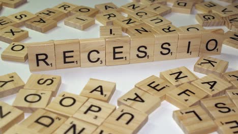 Economics-word-RECESSION-formed-on-table-with-Scrabble-game-tiles