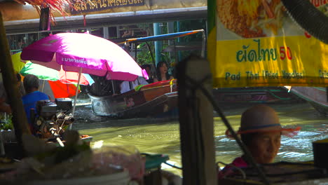 Tourists-exploring-by-boat-a-floating-market-in-Bangkok