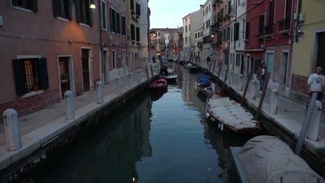 Boats-Parked-in-Water-Canal-in-Venice-on-a-Late-Evening